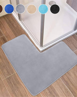 Soft coral fleece corner shower bath mat with non-slip backing, designed for bathroom floors by Problems Solved.