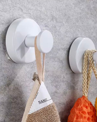 Metal suction cup hook from Problems Solved, bathroom towel holder with strong grip and sleek silver finish attached to a bathroom wall.