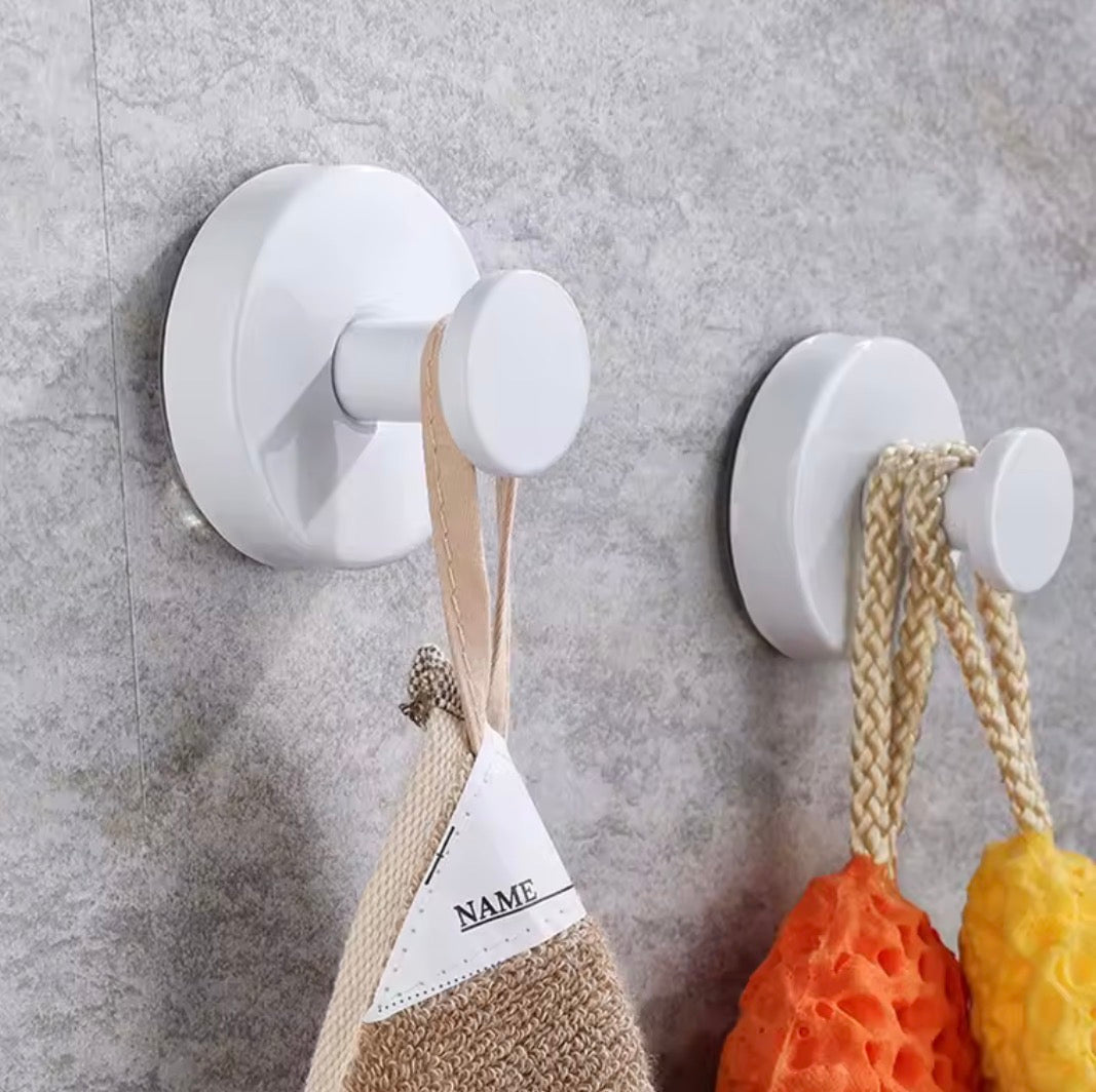 Metal suction cup hook from Problems Solved, bathroom towel holder with strong grip and sleek silver finish attached to a bathroom wall.