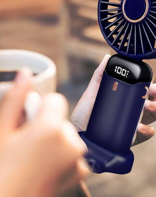 Problems Solved portable handheld USB rechargeable fan with five speed settings, shown in use with compact design and adjustable blades.