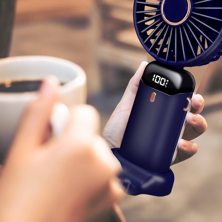 Problems Solved portable handheld USB rechargeable fan with five speed settings, shown in use with compact design and adjustable blades.
