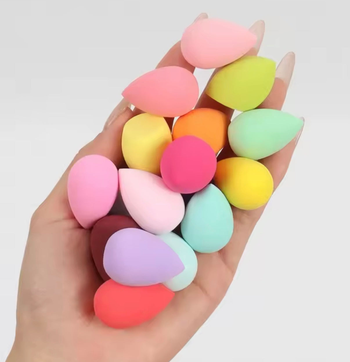 Set of 20 latex-free professional makeup sponges from Problems Solved, showing various sizes and shapes for blending makeup.