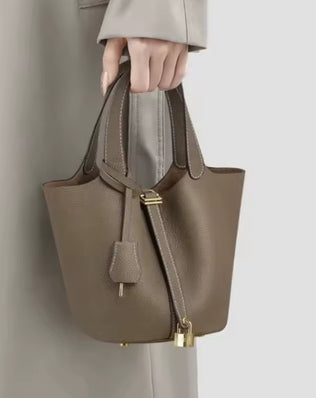 Classic vegetable leather women's bucket handbag by Problems Solved featuring a simple, stylish design with top handle and spacious interior.