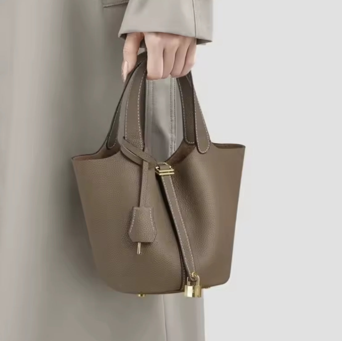 Classic vegetable leather women's bucket handbag by Problems Solved featuring a simple, stylish design with top handle and spacious interior.