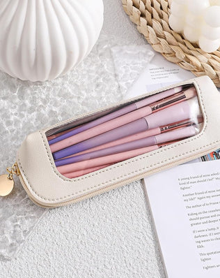 Small clear leather travel makeup bag with transparent design, ideal for storing brushes and cosmetics on the go.