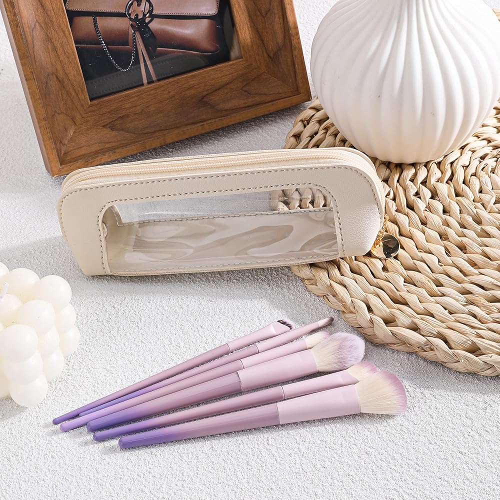 Small clear leather travel makeup bag with transparent design, featuring compartments for makeup brushes and cosmetics by Problems Solved.