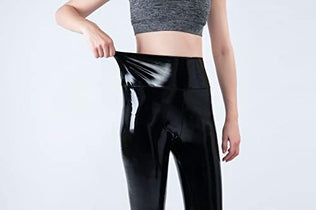 Women mirror faux patent leather leggings by Problems Solved, featuring a reflective shiny stretch finish and form-fitting design.