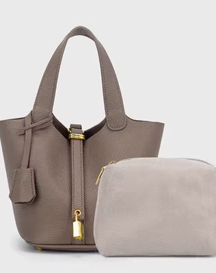 Classic vegetable leather women's bucket handbag by Problems Solved, showcasing a simple, stylish design with a rounded shape and handle.