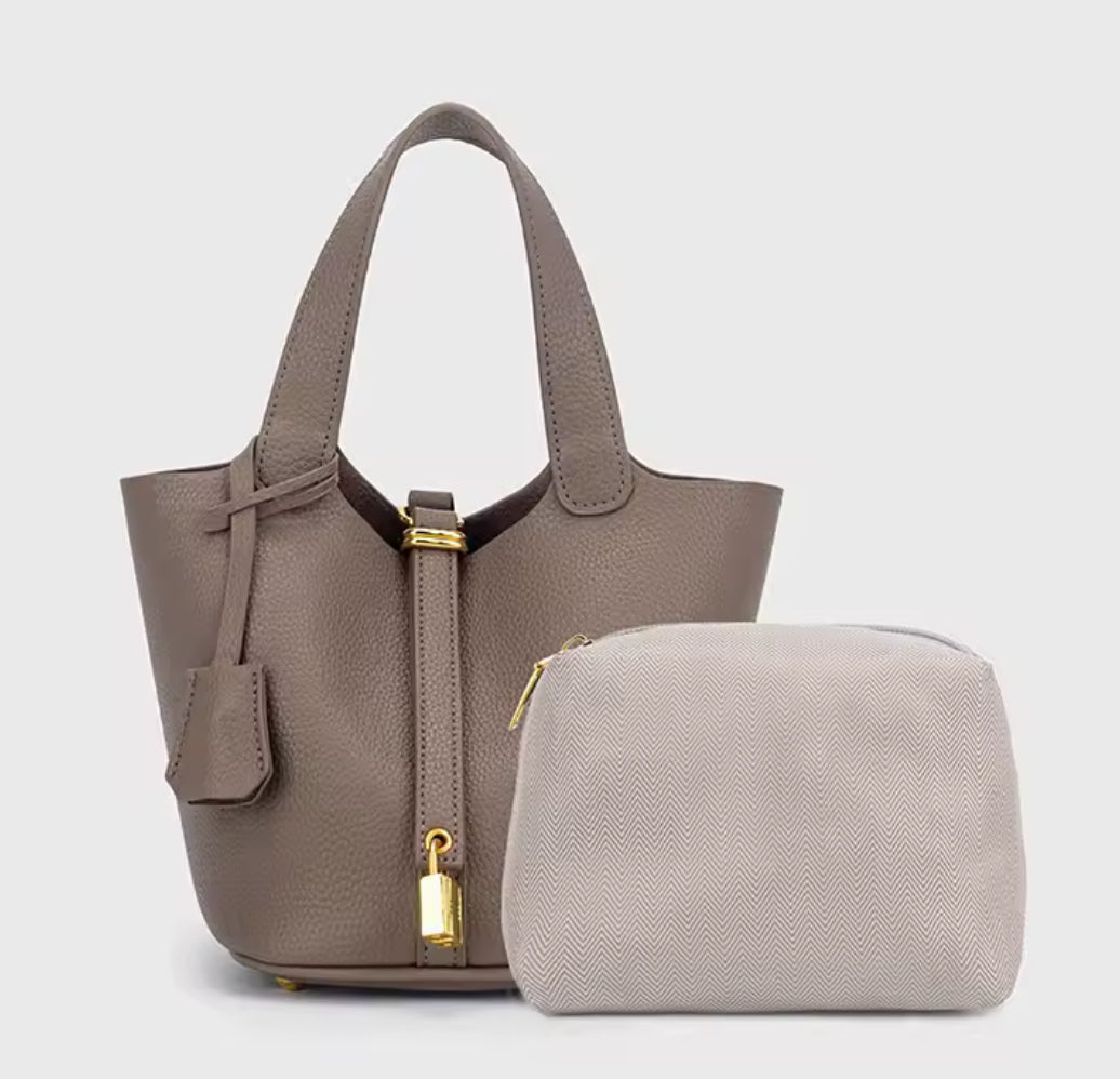 Classic vegetable leather women's bucket handbag by Problems Solved, showcasing a simple, stylish design with a rounded shape and handle.
