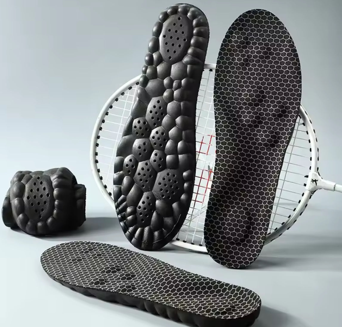 Two pairs of breathable, soft shoe pads from Problems Solved designed for comfortable foot massage and support inside shoes.