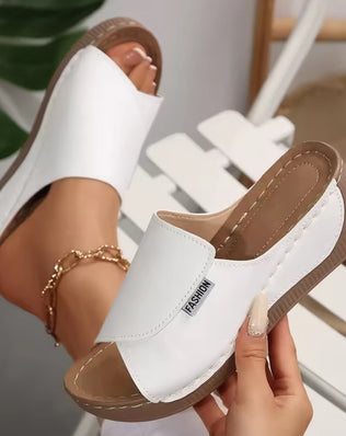 Women’s wedge slippers by Problems Solved featuring summer fashion design, casual slip-ons with comfortable wedge heel.