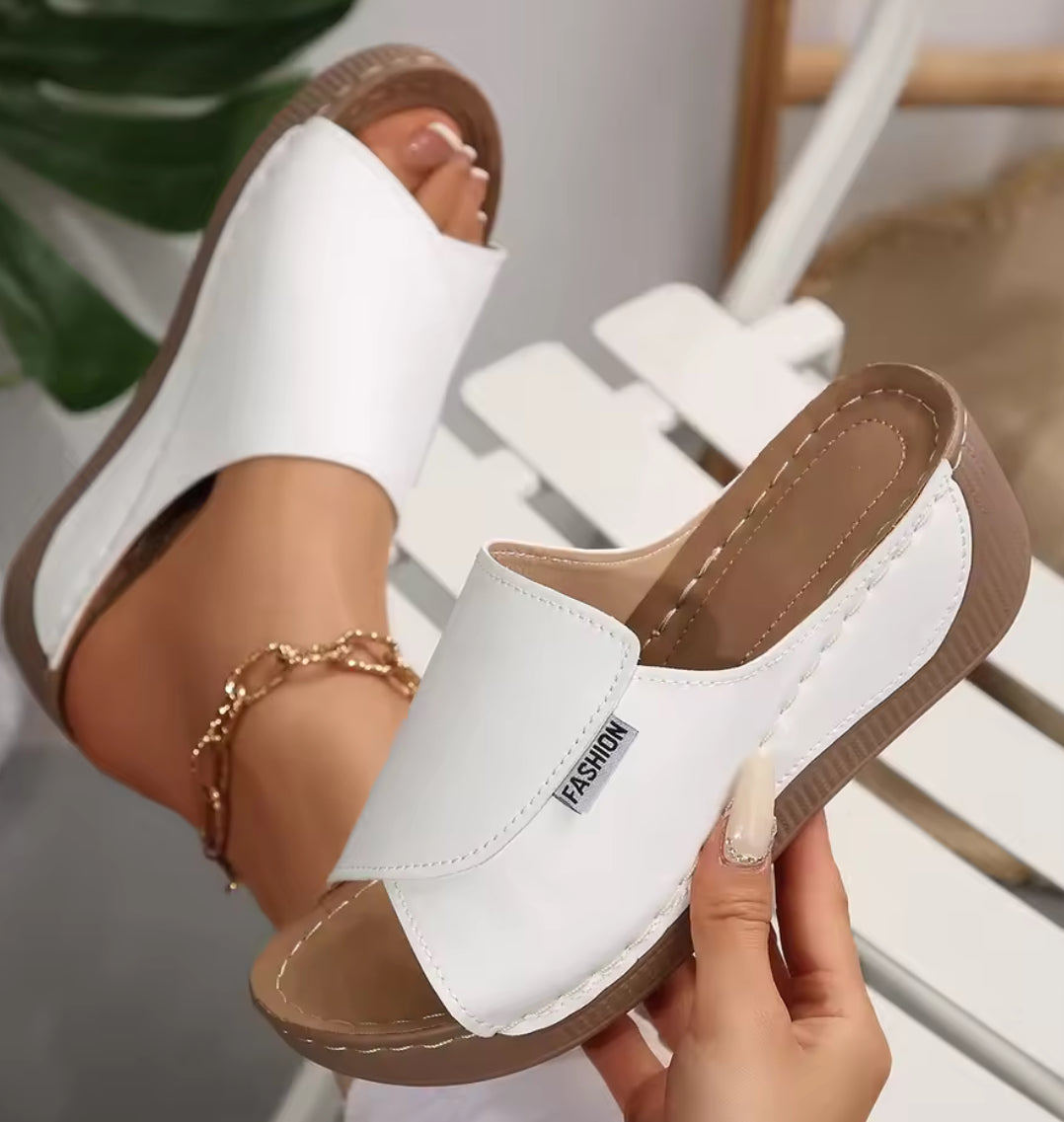 Women’s wedge slippers by Problems Solved featuring summer fashion design, casual slip-ons with comfortable wedge heel.