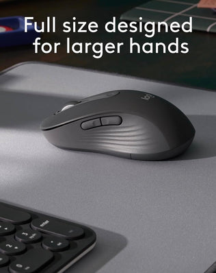 Problems Solved Signature M650 L wireless mouse shown with full size ergonomic design and USB receiver on a desk.