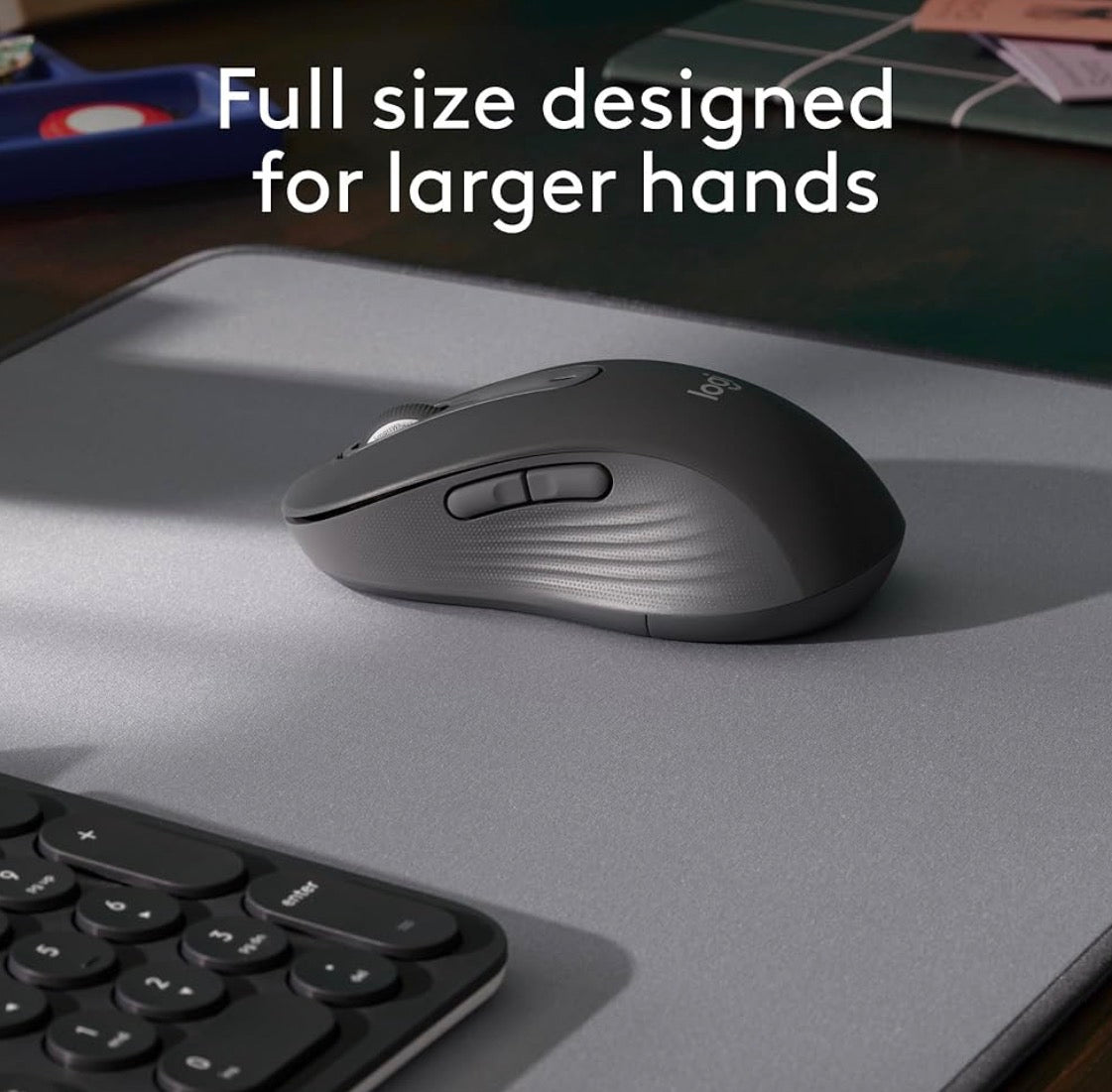 Problems Solved Signature M650 L wireless mouse shown with full size ergonomic design and USB receiver on a desk.