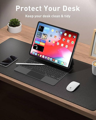 Leather desk pad protector and mouse pad by Problems Solved, non-slip PU leather office desk mat on a workspace.