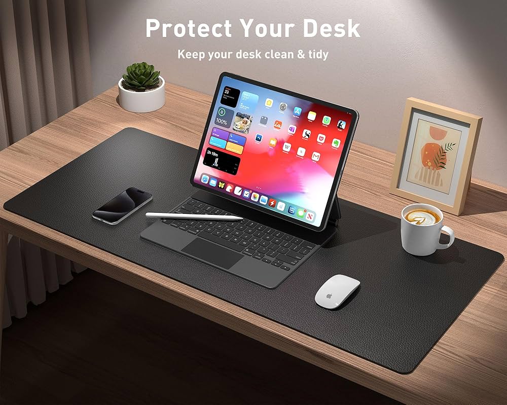 Leather desk pad protector and mouse pad by Problems Solved, non-slip PU leather office desk mat on a workspace.