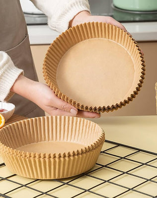 Set of 100 disposable air fryer paper liners by Problems Solved, round 7.9-inch size, suitable for preventing mess in air fryers.