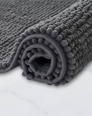 Non-slip, super absorbent bathroom mat from Problems Solved, machine washable bath mat with textured surface for safety.