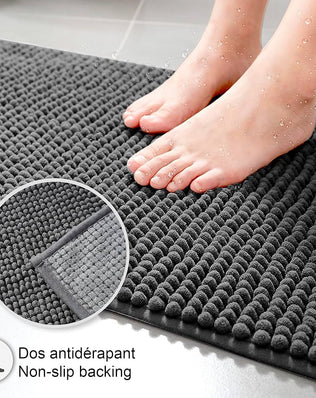 Problems Solved non-slip bath mat, super absorbent and machine washable bathroom mat shown on a bathroom floor.