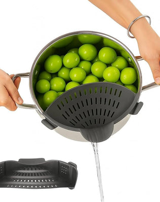 Silicone clip-on pot strainer from Problems Solved, heat-resistant kitchen drainer for pots and pans, shown in use on a stove