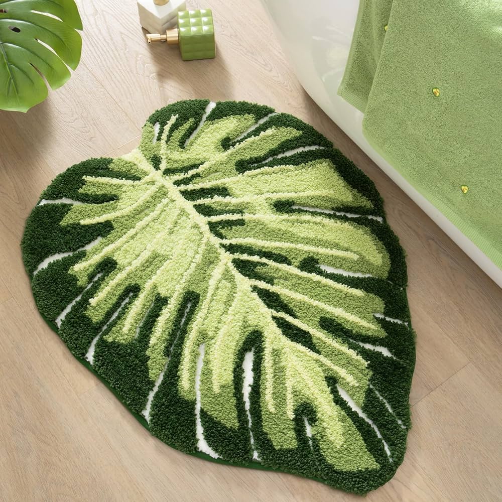 Green Monstera leaf bathroom rug, tropical plant-shaped bath mat by Problems Solved, soft shower mat for bathroom decor