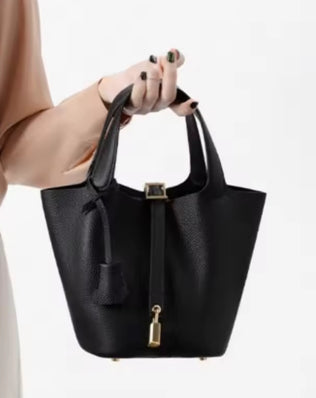Classic vegetable leather women's bucket handbag by Problems Solved, featuring a simple, stylish design and spacious interior.