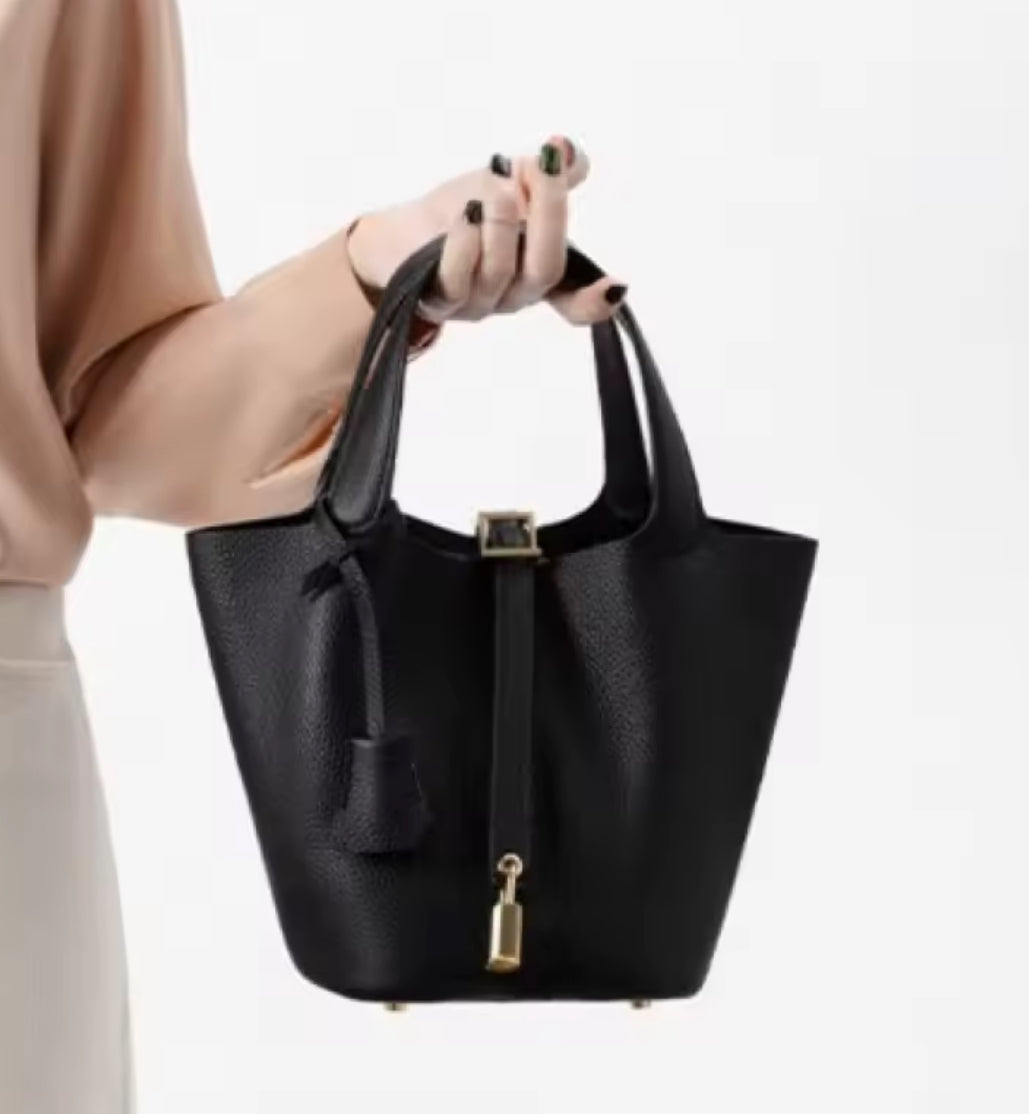Classic vegetable leather women's bucket handbag by Problems Solved, featuring a simple, stylish design and spacious interior.