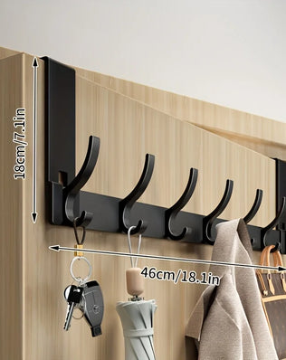 Bathroom shower storage rack by Problems Solved, made of space aluminum with towels hanging, easy to install in the bathroom.