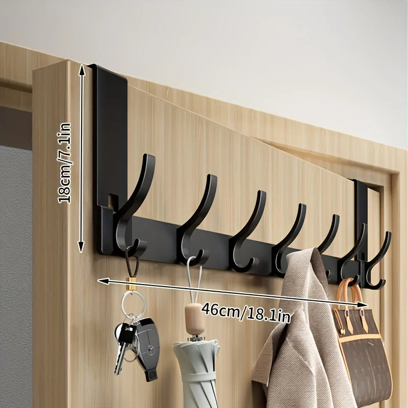 Bathroom shower storage rack by Problems Solved, made of space aluminum with towels hanging, easy to install in the bathroom.