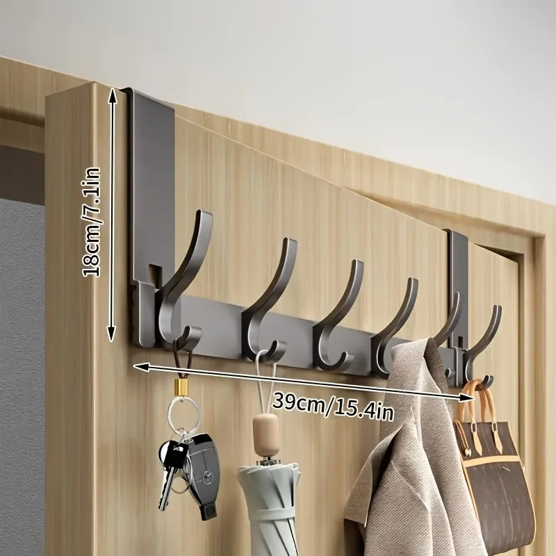 Bathroom shower storage rack by Problems Solved, made of space aluminum, with towels hanging, easy to install in a modern bathroom.