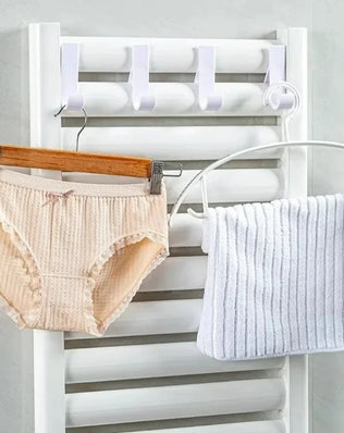 Heated bathroom shower towel holder radiator rail by Problems Solved, with sleek metal bars for hanging towels and heating function.