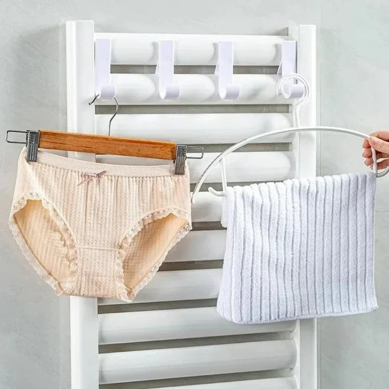 Heated bathroom shower towel holder radiator rail by Problems Solved, with sleek metal bars for hanging towels and heating function.