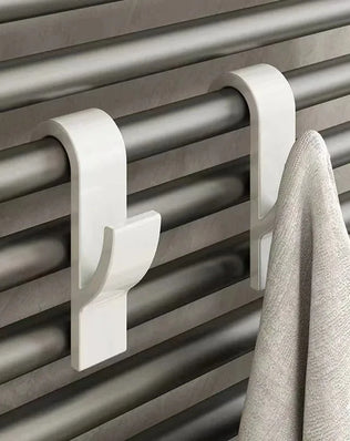 Heated bathroom shower towel holder and radiator rail by Problems Solved, featuring a sleek, modern design with multiple towel hooks.