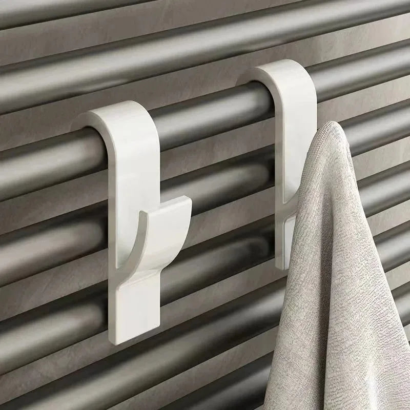 Heated bathroom shower towel holder and radiator rail by Problems Solved, featuring a sleek, modern design with multiple towel hooks.